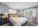 Bedroom features a stylish gray bed frame, dark wood nightstands, and patterned curtains at 913 Moss Ln, Winter Park, FL 32789