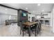 Open-concept dining area with a large wood table, black brick accent wall, and views into the kitchen and living room at 913 Moss Ln, Winter Park, FL 32789