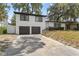 Two-story home with a 2-car garage, dark trim and a concrete driveway at 913 Moss Ln, Winter Park, FL 32789