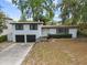 Two-story home with a 2-car garage, dark trim and a concrete driveway at 913 Moss Ln, Winter Park, FL 32789