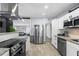Open kitchen layout with stainless steel appliances, white cabinets, granite countertops, and easy access to living spaces at 913 Moss Ln, Winter Park, FL 32789