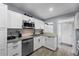 Updated kitchen showcasing white cabinets, stainless appliances, granite countertops, and stylish fixtures at 913 Moss Ln, Winter Park, FL 32789