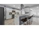 Bright kitchen with granite counters, stainless steel appliances, a breakfast bar, and sleek white cabinetry at 913 Moss Ln, Winter Park, FL 32789