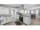 Modern kitchen with stainless appliances, granite countertops, a black range, and a seamless flow to the dining area at 913 Moss Ln, Winter Park, FL 32789
