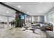 Spacious living room with a gray sofa, wood-look floors, and a brick fireplace at 913 Moss Ln, Winter Park, FL 32789