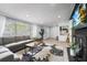 Cozy living room with large windows, gray sofa, and a stylish floral rug at 913 Moss Ln, Winter Park, FL 32789