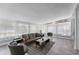 Bright living room featuring stylish seating, decorative rug, and light filled windows with sheer curtains at 913 Moss Ln, Winter Park, FL 32789