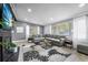 Bright living room featuring gray walls, large windows, and a comfortable gray sectional sofa at 913 Moss Ln, Winter Park, FL 32789