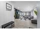 Open-concept living room featuring wood floors, gray walls, a brick fireplace and comfortable seating at 913 Moss Ln, Winter Park, FL 32789