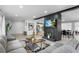 Open-concept living room featuring wood floors, gray walls, a brick fireplace and comfortable seating at 913 Moss Ln, Winter Park, FL 32789