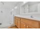 Bathroom featuring white cabinets, a large mirror, and a glass enclosed shower at 939 Glen Abbey Cir, Winter Springs, FL 32708