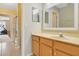 Bright bathroom with a vanity, two mirrors and hallway access to bedroom and exercise room at 939 Glen Abbey Cir, Winter Springs, FL 32708