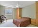 Cozy bedroom featuring a ceiling fan, neutral walls, and a comfortable bed at 939 Glen Abbey Cir, Winter Springs, FL 32708
