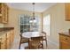 Bright breakfast nook with a round table, overhead lighting, and a large window showcasing the outdoor view at 939 Glen Abbey Cir, Winter Springs, FL 32708