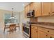 Well-appointed kitchen showcasing stainless steel appliances, granite countertops, and a cozy breakfast nook at 939 Glen Abbey Cir, Winter Springs, FL 32708