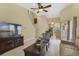 Open-concept living room with soaring ceilings, tile floors, and access to the kitchen and lanai at 939 Glen Abbey Cir, Winter Springs, FL 32708