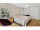Comfortable bedroom with wood flooring and a large window offering natural light at 939 Glen Abbey Cir, Winter Springs, FL 32708