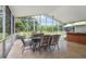 Covered screened porch with a dining table, chairs, and a hot tub, great for outdoor relaxation at 939 Glen Abbey Cir, Winter Springs, FL 32708
