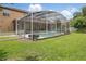 Lush backyard featuring a pristine, screened pool, a well-manicured lawn, and an inviting outdoor space at 108 Sagecrest Dr, Ocoee, FL 34761