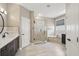 Bathroom with a white subway tile shower and a soaking tub; black fixtures complement the tiled flooring at 108 Sagecrest Dr, Ocoee, FL 34761