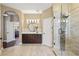 Bathroom with a glass shower and modern vanity; the open doorway shows a glimpse of the living area at 108 Sagecrest Dr, Ocoee, FL 34761