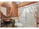Unique bathroom features a vessel sink, decorative mirror, and a glass shower stall with patterned curtains at 108 Sagecrest Dr, Ocoee, FL 34761
