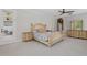 Spacious bedroom with a wooden bed frame, neutral carpet, a ceiling fan and light-filled sliding doors to a patio at 108 Sagecrest Dr, Ocoee, FL 34761