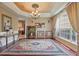 Formal dining room featuring a decorative ceiling, elegant chandelier, and large windows for natural light at 108 Sagecrest Dr, Ocoee, FL 34761