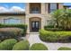 Elegant front entrance with glass paneled door and well-maintained landscaping, leading to a welcoming home at 108 Sagecrest Dr, Ocoee, FL 34761