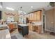 Well-lit kitchen with stainless steel appliances, an island, tiled floor and light wood cabinetry at 108 Sagecrest Dr, Ocoee, FL 34761