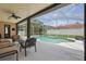 Relaxing screened-in pool area with comfortable seating under a covered patio, perfect for leisure and gatherings at 108 Sagecrest Dr, Ocoee, FL 34761