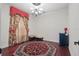 Room with dark floors, a red accent rug, a chandelier, and dramatic curtains that frame the window at 108 Sagecrest Dr, Ocoee, FL 34761