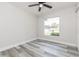 Well-lit bedroom with a ceiling fan, large window, and wood-look floors at 1105 Valencia Ave, Haines City, FL 33844