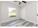 Cozy bedroom featuring a ceiling fan, closet, and window at 1105 Valencia Ave, Haines City, FL 33844