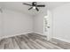 Neutral bedroom with ceiling fan, closet, and gray wood look floors at 1105 Valencia Ave, Haines City, FL 33844