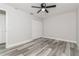 Neutral bedroom featuring closet, ceiling fan, and gray wood look flooring at 1105 Valencia Ave, Haines City, FL 33844