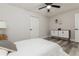 Neutral bedroom featuring a ceiling fan, modern wood flooring, white walls, and stylish built-in storage at 1105 Valencia Ave, Haines City, FL 33844