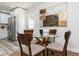 Charming dining area adjacent to a modern kitchen, featuring a round glass table with seating for four at 1105 Valencia Ave, Haines City, FL 33844