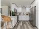Modern kitchen featuring white cabinets, stainless steel appliances, and wood-look flooring at 1105 Valencia Ave, Haines City, FL 33844