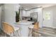 Bright kitchen featuring stainless steel appliances, white cabinets, and quartz countertops with breakfast bar seating at 1105 Valencia Ave, Haines City, FL 33844