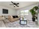 Cozy living room featuring a comfortable sofa, stylish rug, and ample natural light from a large window at 1105 Valencia Ave, Haines City, FL 33844