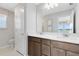 Bathroom featuring a double sink vanity and a large mirror at 11328 Blue Bay Dr, Orlando, FL 32832