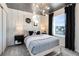 Stylish bedroom with a modern light fixture, dark curtains, and decorative wall art at 11328 Blue Bay Dr, Orlando, FL 32832