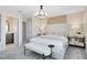 Neutral bedroom with a upholstered headboard, bench, and ensuite bathroom entrance at 11328 Blue Bay Dr, Orlando, FL 32832