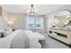 Bright bedroom featuring a large window and a stylish dresser at 11328 Blue Bay Dr, Orlando, FL 32832