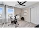 Home gym includes stationary bike, large mirror, and a ceiling fan at 11328 Blue Bay Dr, Orlando, FL 32832