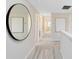 Hallway featuring plush carpeting, neutral walls and a large round mirror at 11328 Blue Bay Dr, Orlando, FL 32832