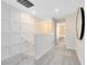 Upstairs hallway featuring decorative wall paneling and plush carpeting at 11328 Blue Bay Dr, Orlando, FL 32832