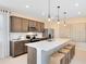 Bright kitchen boasts stainless appliances, an island with seating, and pendant lighting at 11328 Blue Bay Dr, Orlando, FL 32832
