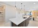 Bright, open kitchen with a large island featuring seating, sink, and modern fixtures at 11328 Blue Bay Dr, Orlando, FL 32832